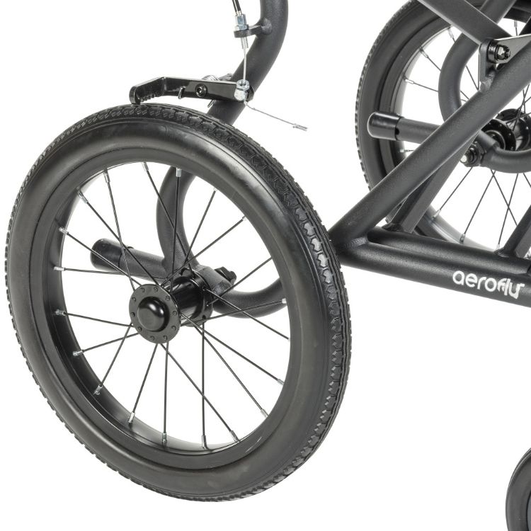 Close-up of the Drive Medical transport chair lightweight spoke wheel with treaded flat-free tire.