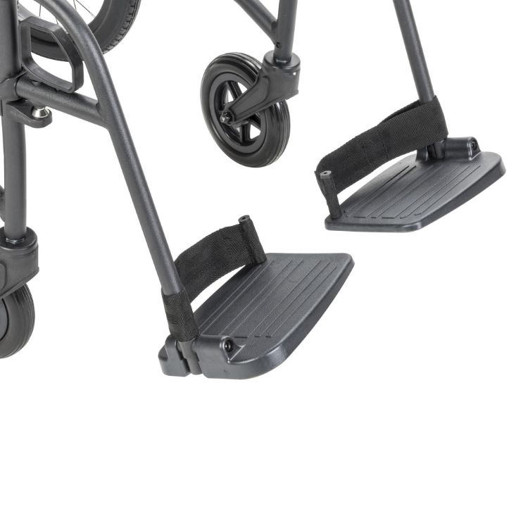 Close-up of the Drive Medical transport chair European-style swing-away footrests with ergonomic release levers.